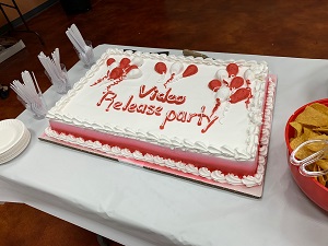 A cake on a table with "Video Release Party" written in frosting.