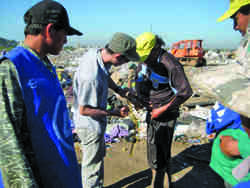 EOH student places personal air sampler on a unionized trash picker in Paraguay. Photo courtesy of Rad Cunningham.