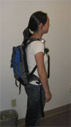Person with a personal air sampling device on a backpack.