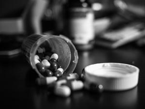 Researchers say guidelines that focus on chronic, high-dose use may need revision. Bottle of prescription pills on its side with pills spilling out