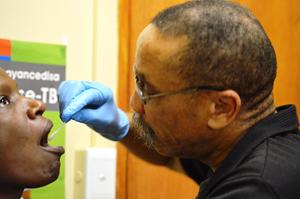 A medical staffer in Cape Town, South Africa, collects a patient's swab sample. A medical staffer in Cape Town, South Africa, collects a patient's swab sample.