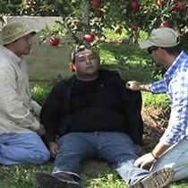 still from video about heat illness that shows two men, one collapsed still from video about heat illness that shows two men, one collapsed