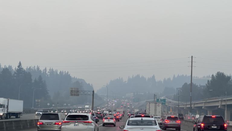 Cars driving through wildfire smoke