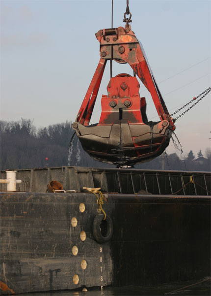 Dredge bucket over water at Duwamish River clean up site