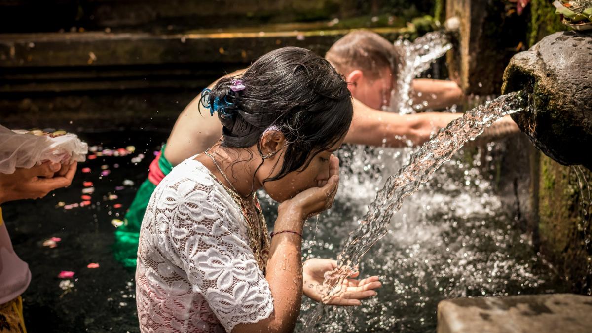 People drinking from water fountains