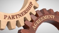 interlocking gears with the words "partnership" and "agreement"