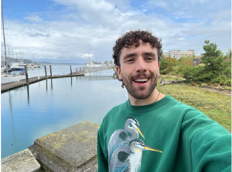 Student standing in front of a river