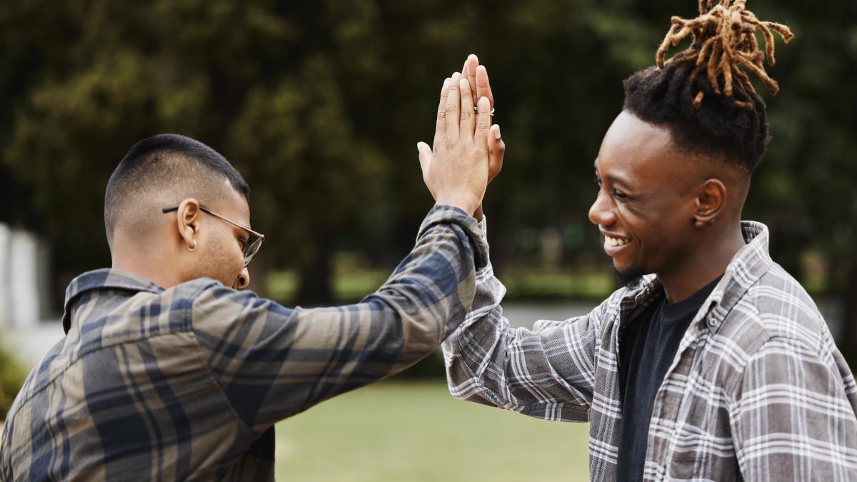 Shot of two young men giving each other a high five 