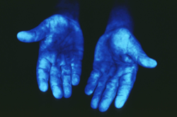 Hands under black light.