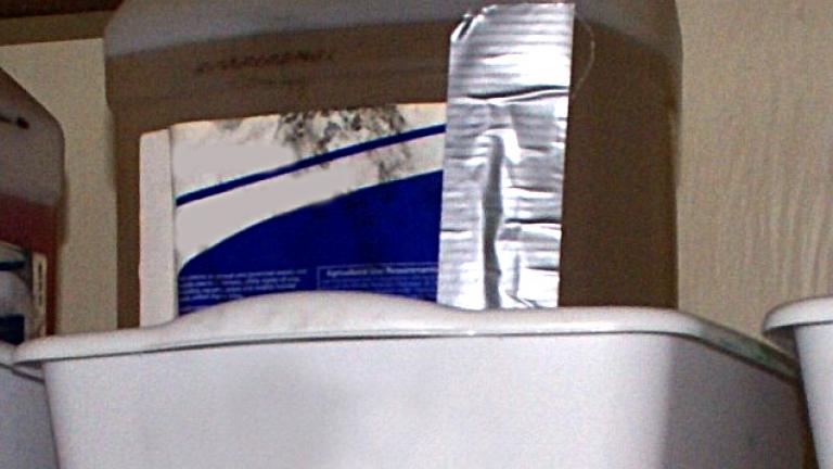 Chemical container in tub on a shelf