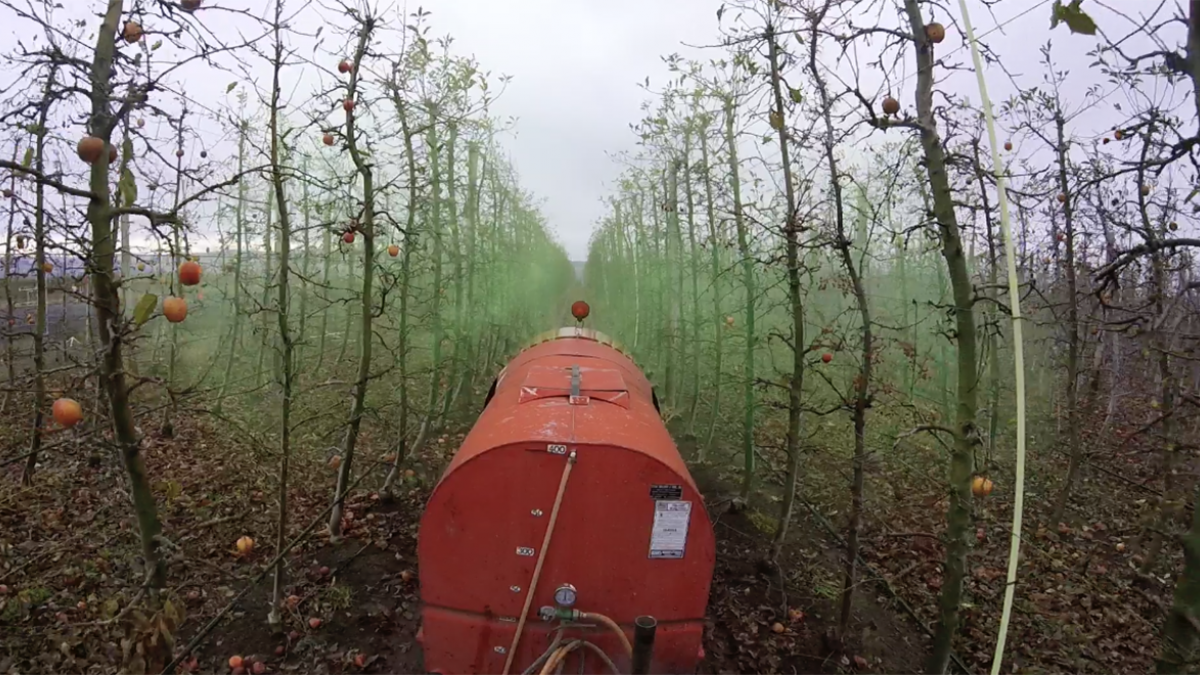 Sprayer in tree fruit field