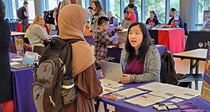 Janet working with student at a degree fair.