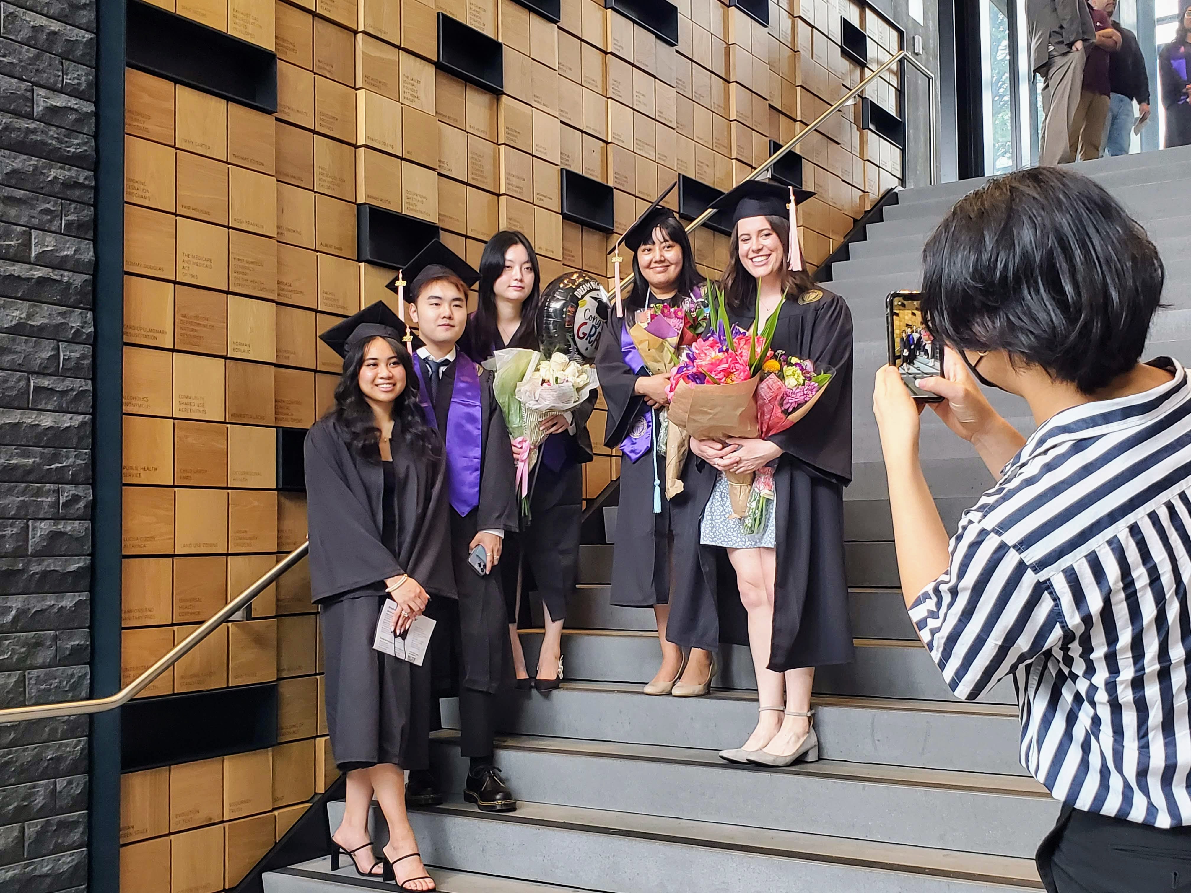 A group of undergraduates poses on the steps for a photo at the Hans Rosling Center for Population Health. 