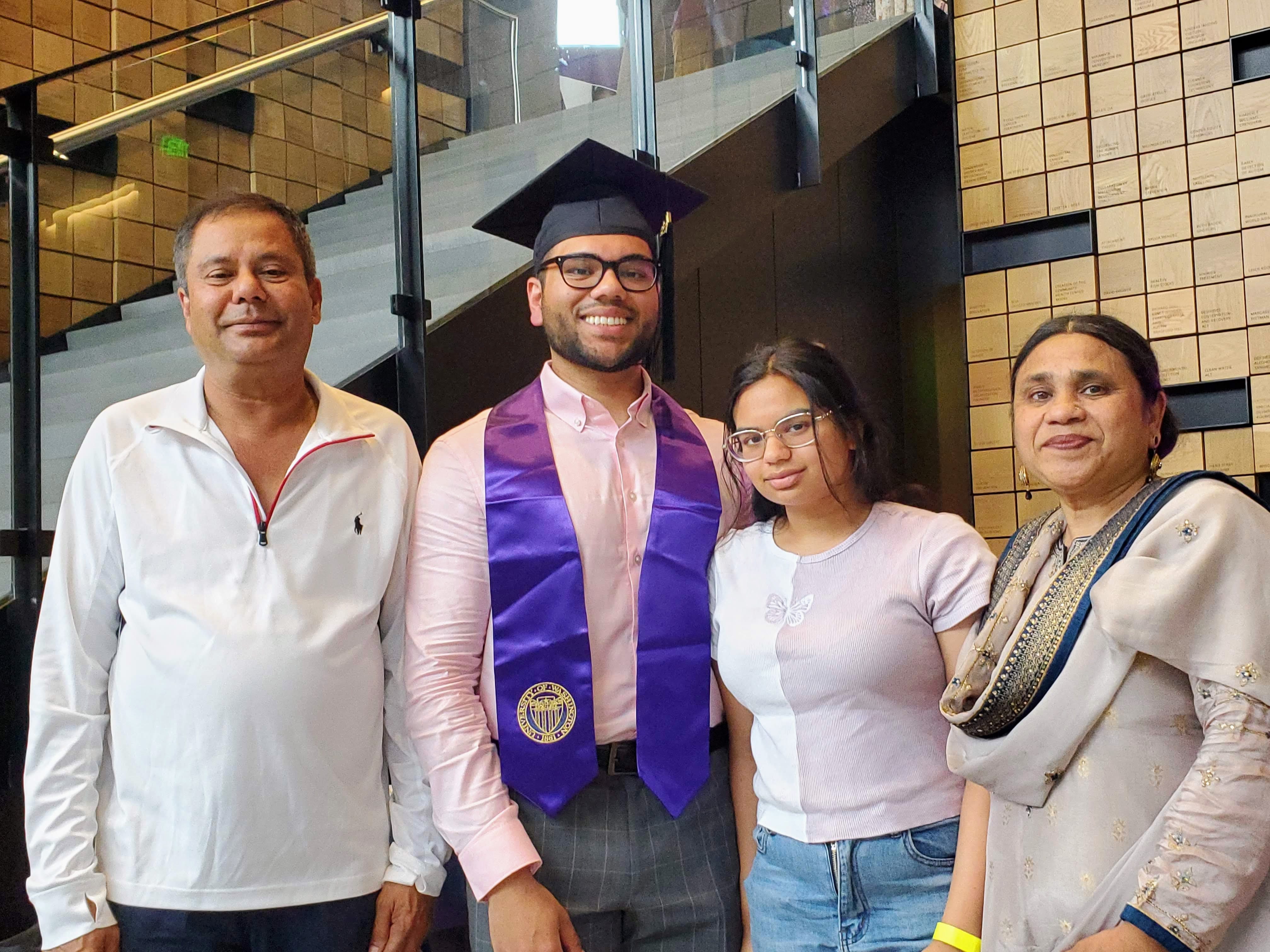 A DEOHS graduate poses with his family at the Hans Rosling Center for Population Health.
