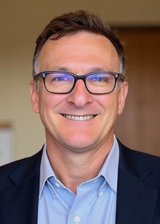 Headshot of a man in a suit