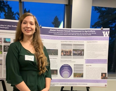 Drury standing in front of a research poster.