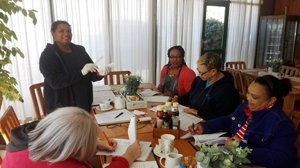 SATVI health care workers sitting at a table with training booklets.