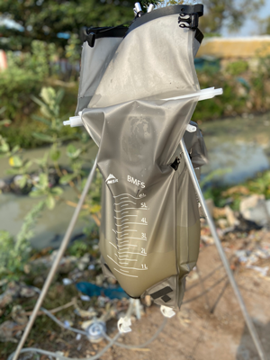 Bag filtration system with stream and vegetation in background.