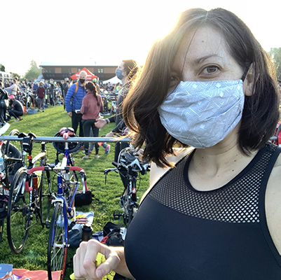 Marsillach in a mask in front of a group of bikes.