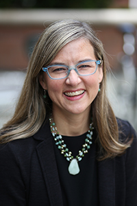 Headshot of Jennifer Otten smiling outside.