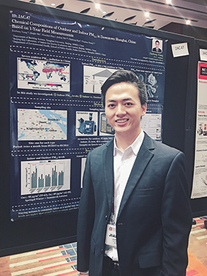 Jianbang Xiang in front of a research poster.