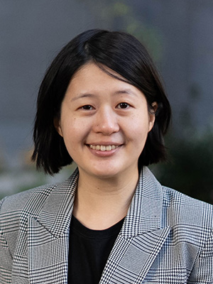 Headshot of Tzu-Hsin Karen Chen smiling with chin-length black hair, wearing a black and white plaid blazer with a black shirt underneath.