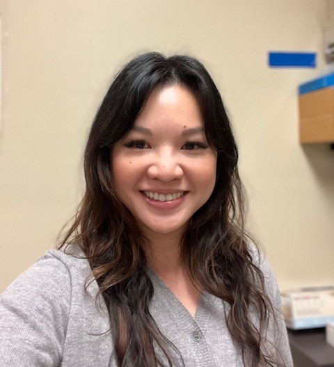 Maria Tchong-French smiles in an interior room.