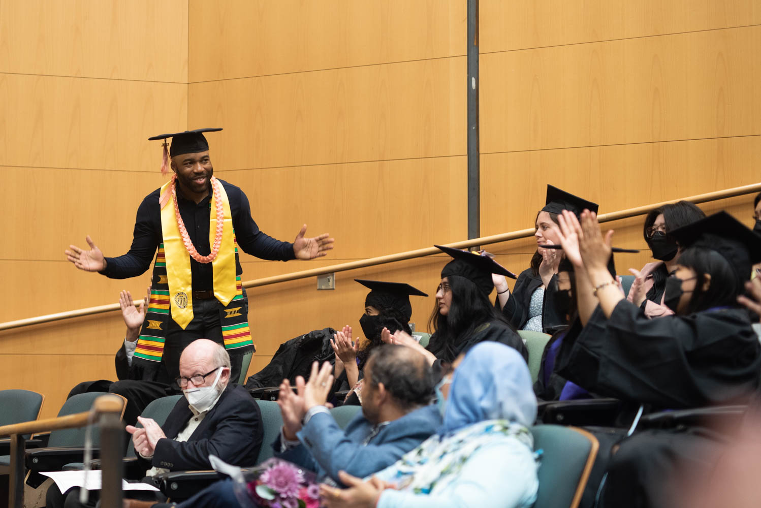 Outstanding Undergraduate Student Amalawa Aiwekhoe acknowledges applause from the audience during the DEOHS graduation ceremony.