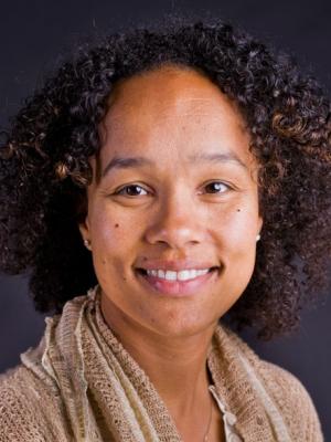Dr Andrasik, a middle-aged black woman with shoulder-length curly hair