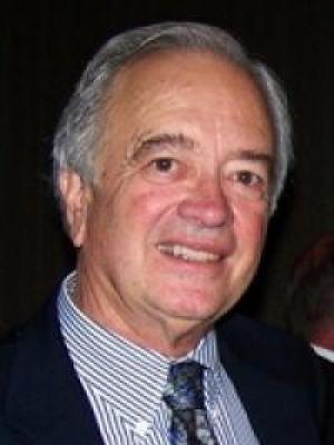 Headshot of Clem Furlong, an older white man with gray hair in a striped shirt and tie
