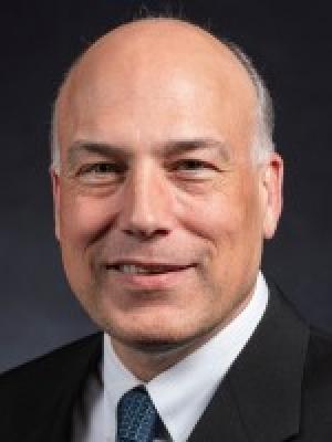 Dr Spielholz, an older balding white man wearing a suit