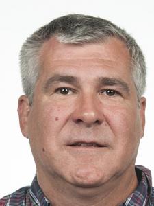 An older white man with short bushy gray hair