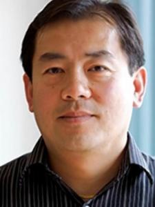 Headshot of Chensheng (Alex) Lu, a middle-aged Asian man with short dark hair