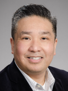 Dr de Castro, a middle-aged Asian man with salt and pepper hair