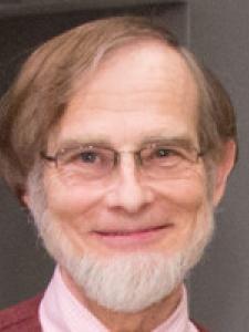 Dr Skilton, an older white man with gray hair and a beard