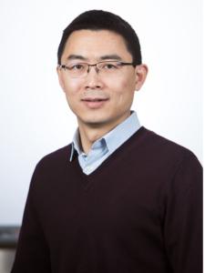 Dr Xu, a middle-aged Asian man with short hair and small glasses