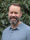 Man with beard smiling at camera