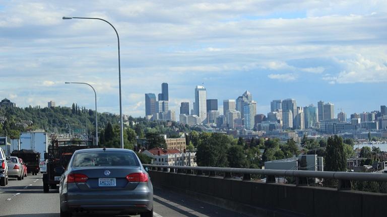 Image of southbound freeway traffic along Lake Union with view of downtown Seattle