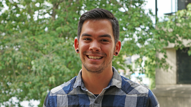 Headshot of man in plaid shirt