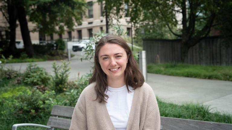 Claire Schollaert sits on a bench on the UW campus.