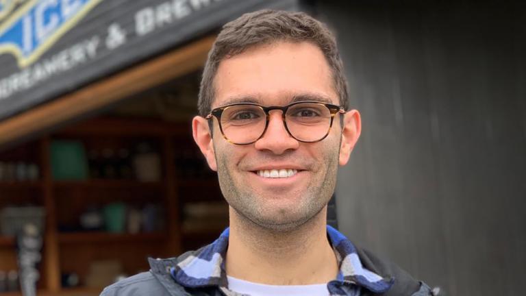 Portrait of Tyler Nicholas in front of Bluebird Ice Cream in Seattle.