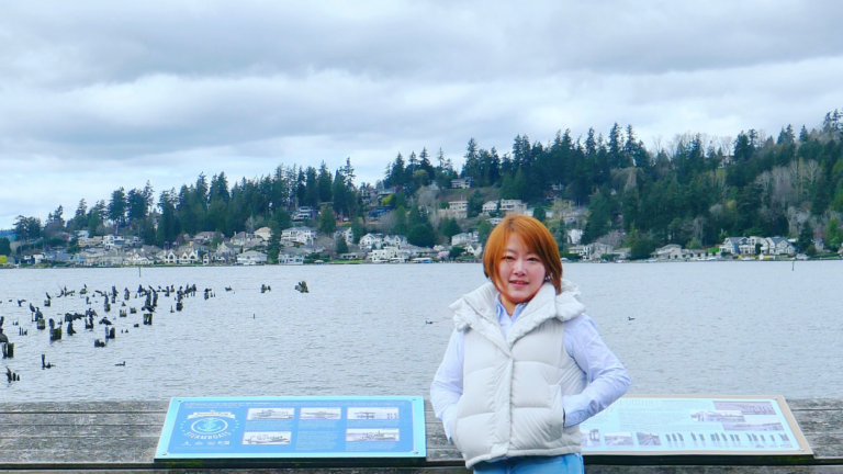 Xinyuan Hao stands in front of a body of water.