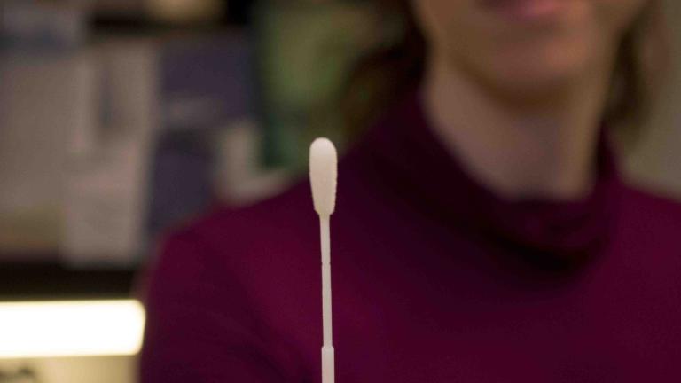 DEOHS research scientist Rachel Wood holds a cotton swab for TB testing.