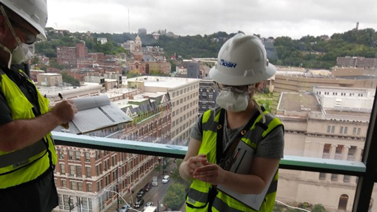 Girl working on a construction site in a NIOSH hard hat