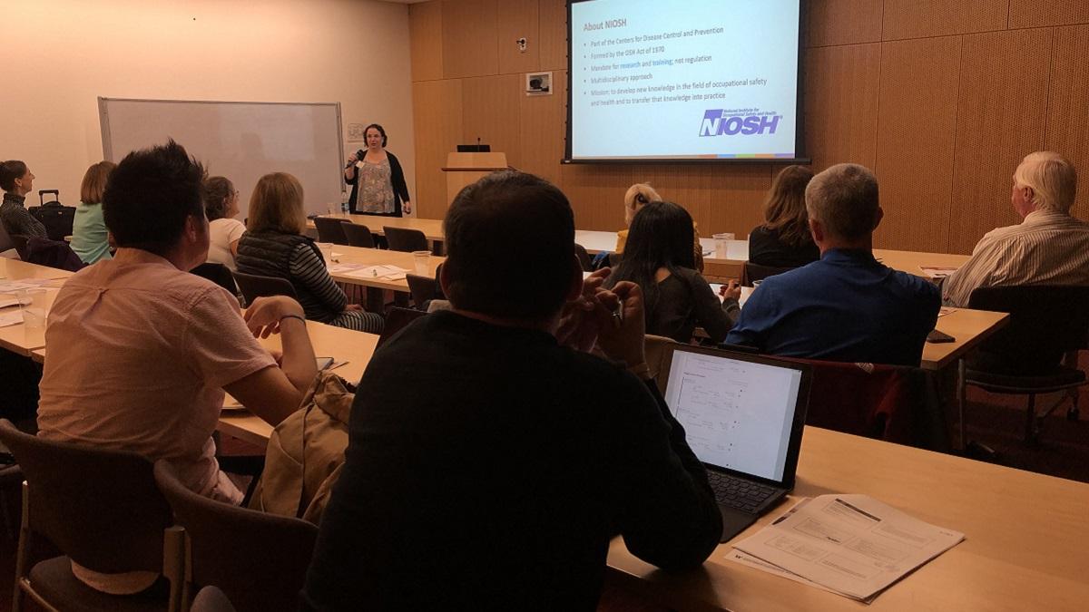 Grand Rounds presenter speaking to a seated group of people