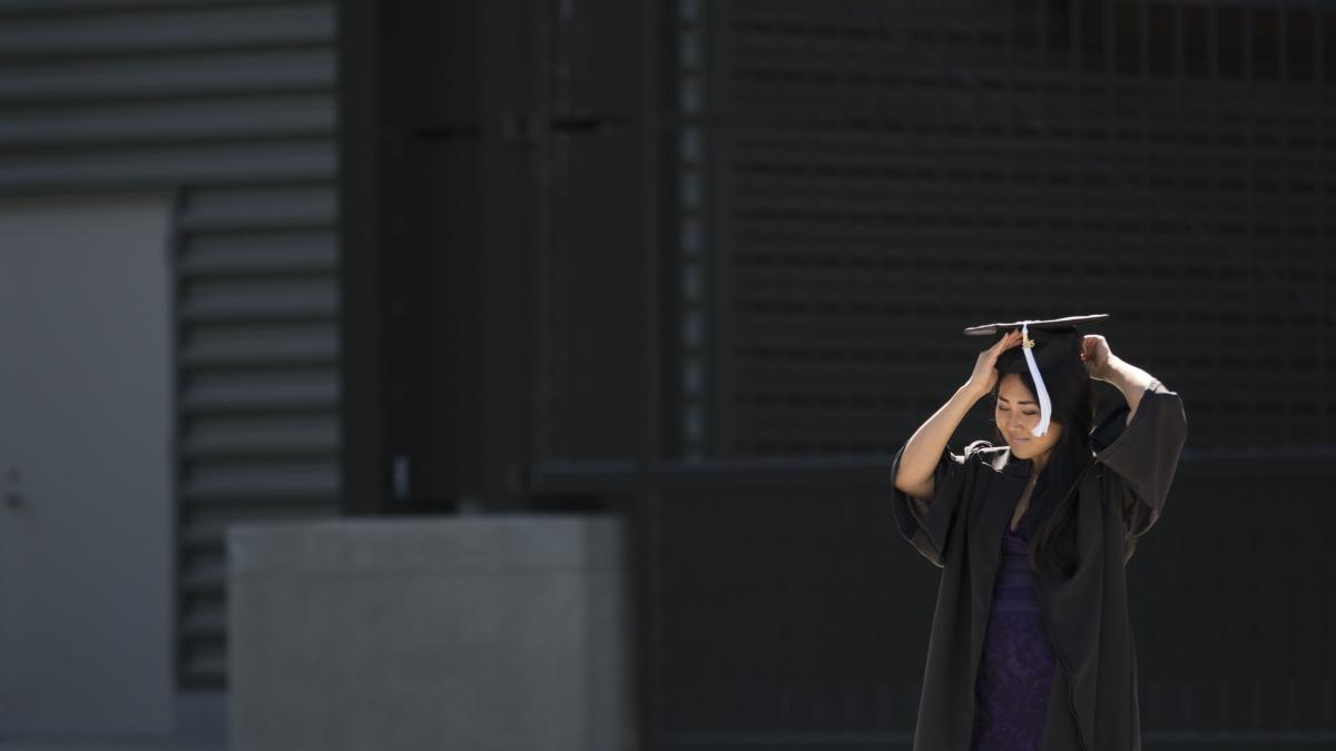 Lady adjusting graduation cap