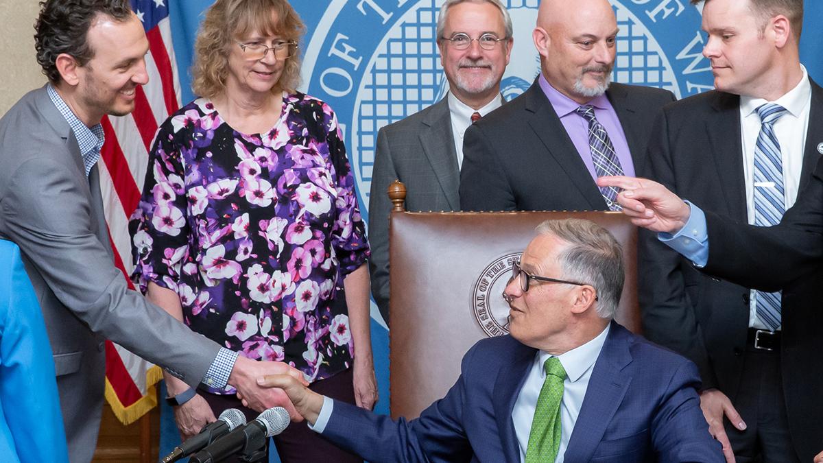 Gov. Inslee signs Senate Bill No. 5233, April 30, 2019. Relating to creating an alternative process for sick leave benefits for workers represented by collective bargaining agreements.