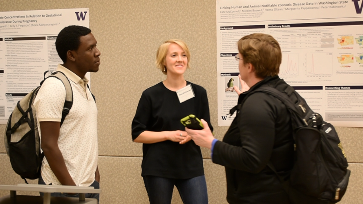Kate McConnell talks with people about her research project at Graduate Student Research Day