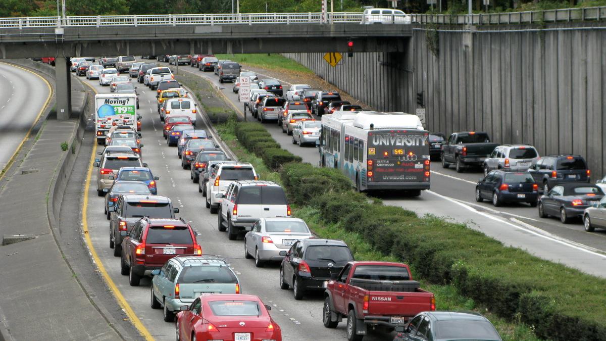 Traffic backed up underneath a bridge.