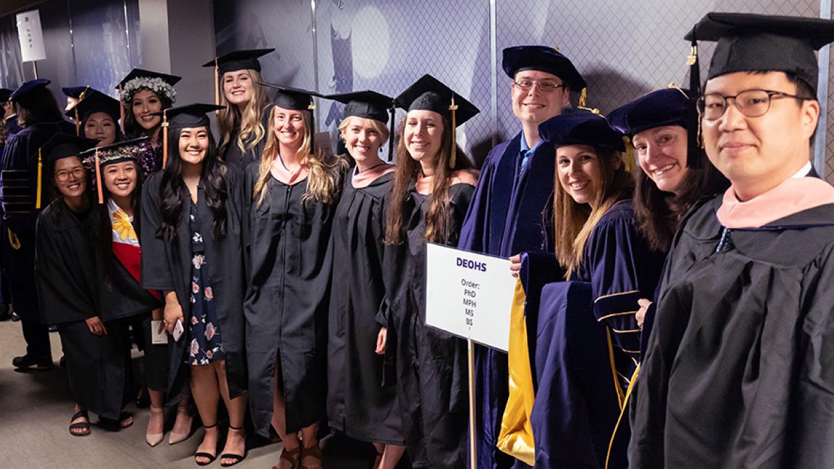 DEOHS Students pose for a photo in the hallway before entering the stadium where the SPH graduation ceremony will take place.